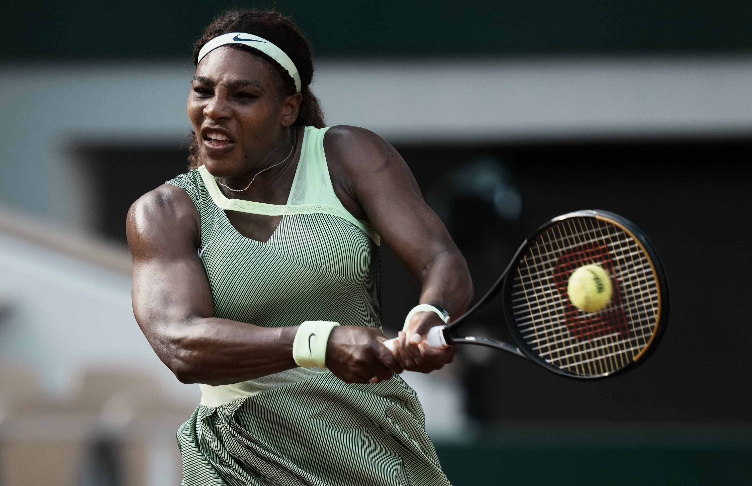 A black woman playing tennis