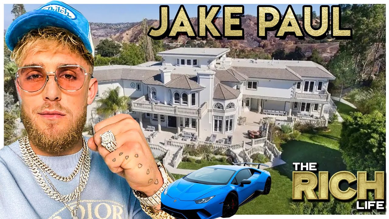 Jake paul wearing a lot of jewelries with a big house and car on his background