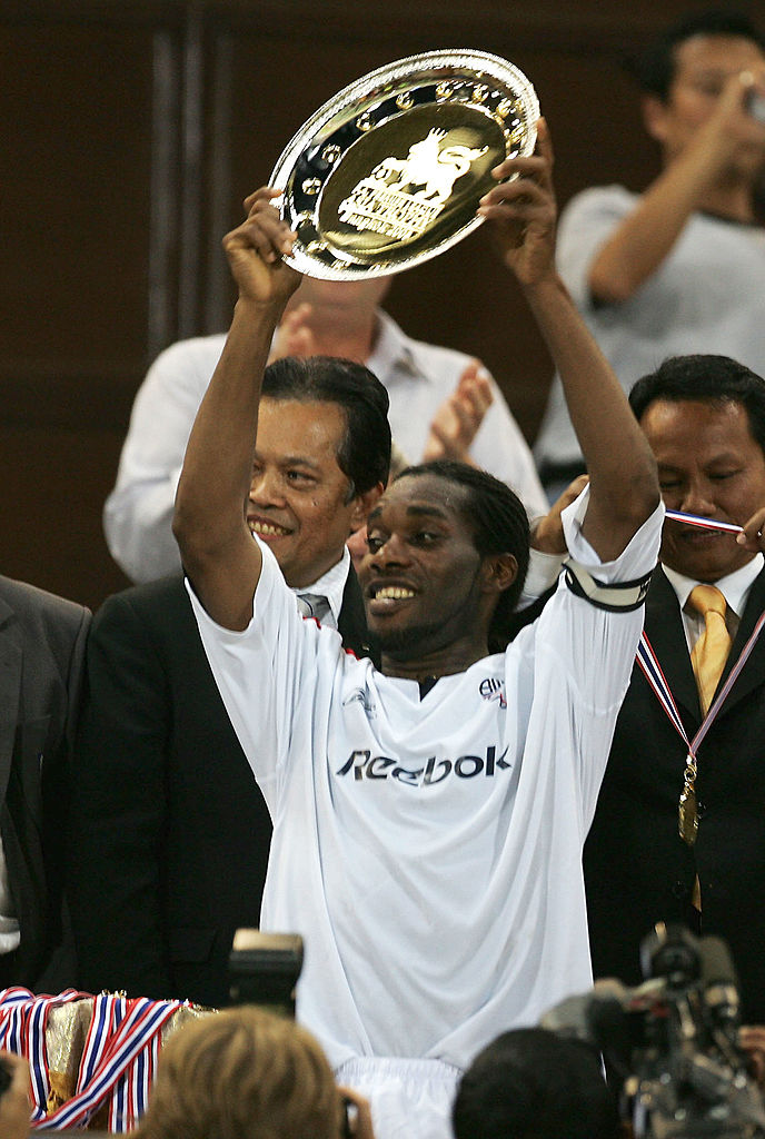 Jay Jay Okocha lifting the Asia Trophy he won with Bolton Wanderers in July 2005