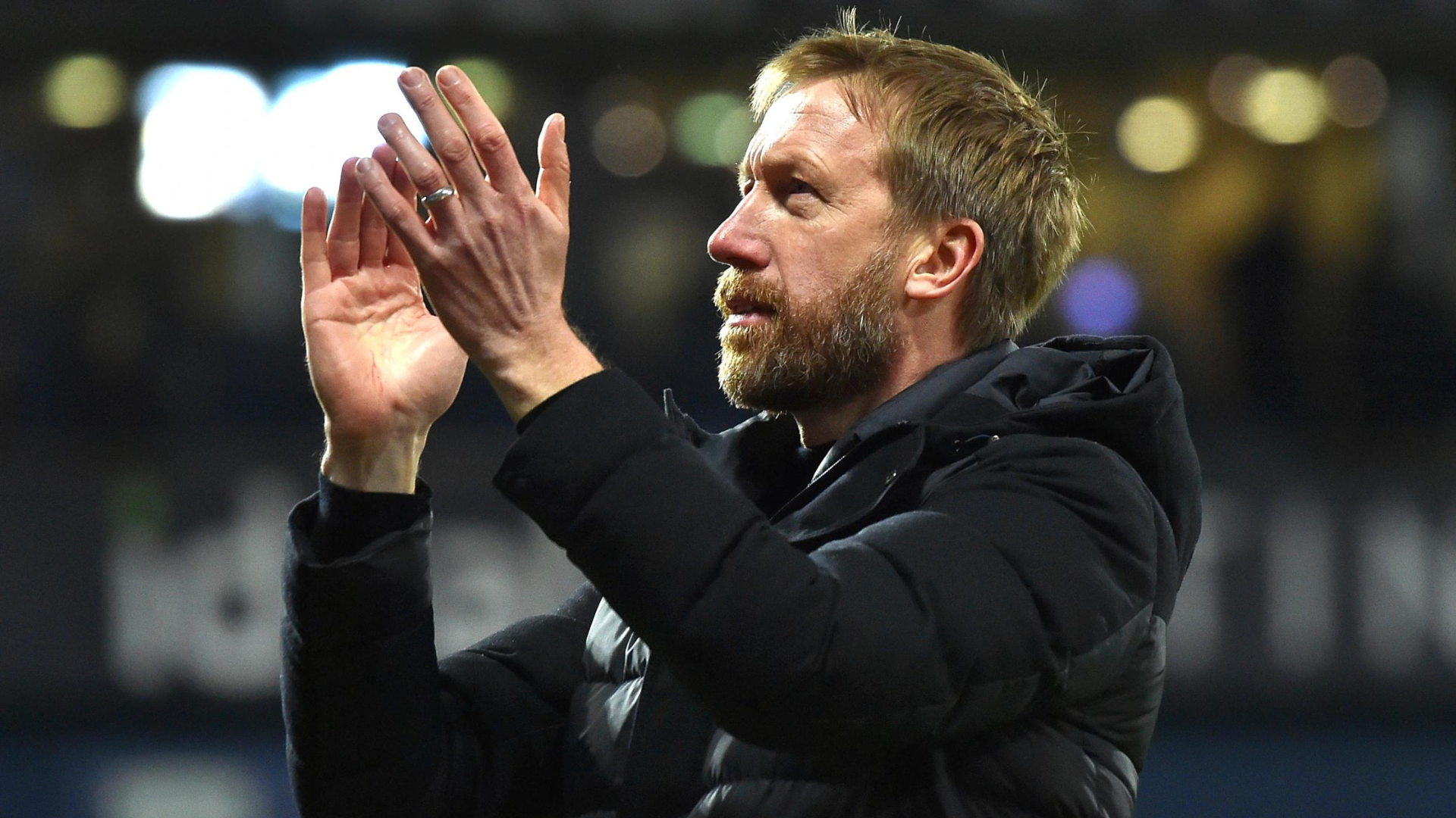 Graham Potter wearing black jacket  and clapping his hands