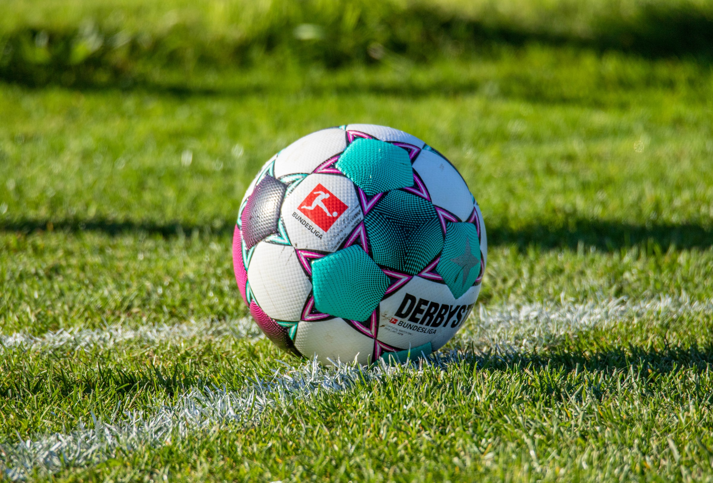 Football Ball With Bundesliga Logo Over The Field of Grass