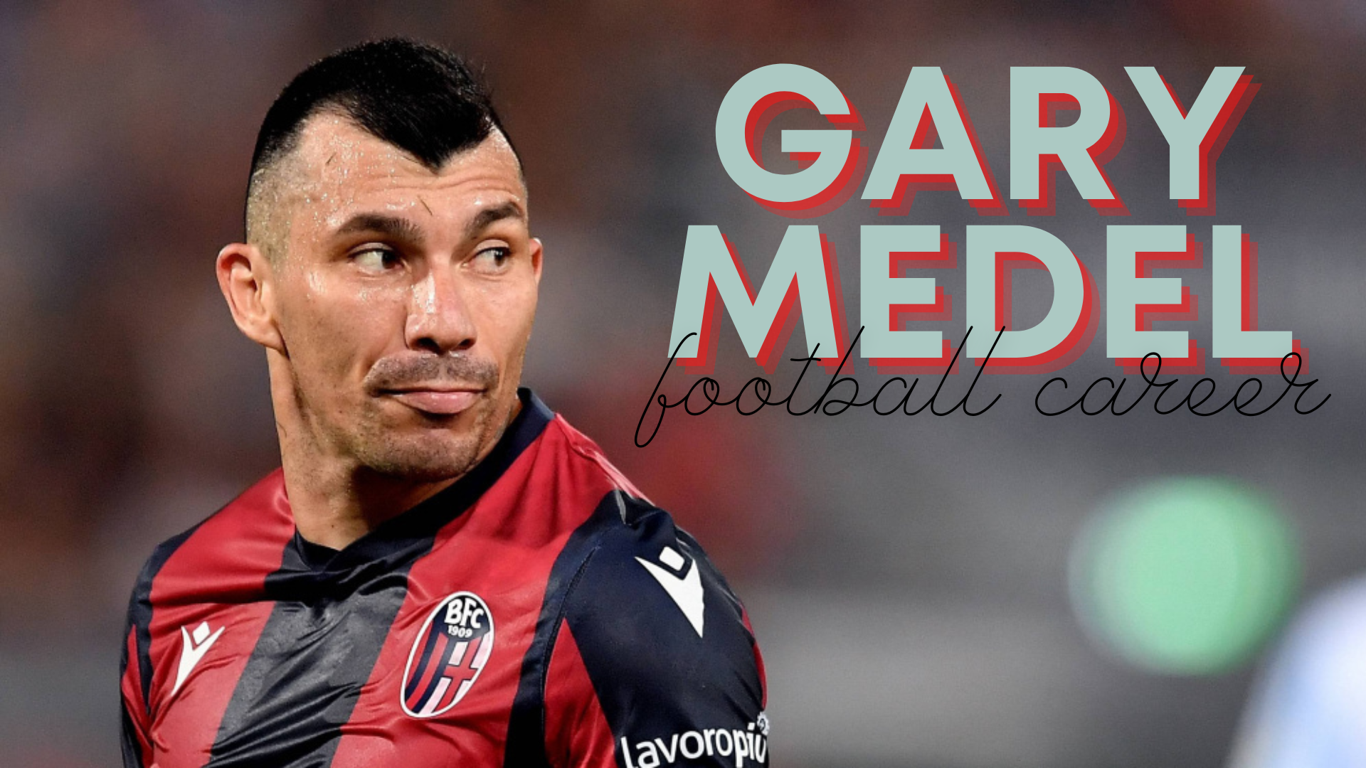 Gary medel standing while wearing colored black and red soccer uniform