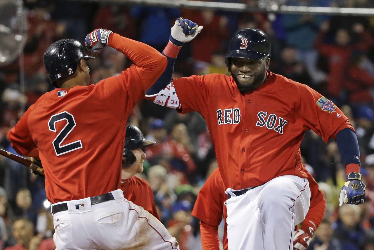 Boston Red Sox designated hitter David Ortiz celebrates his two-run home run with Xander Bogaerts