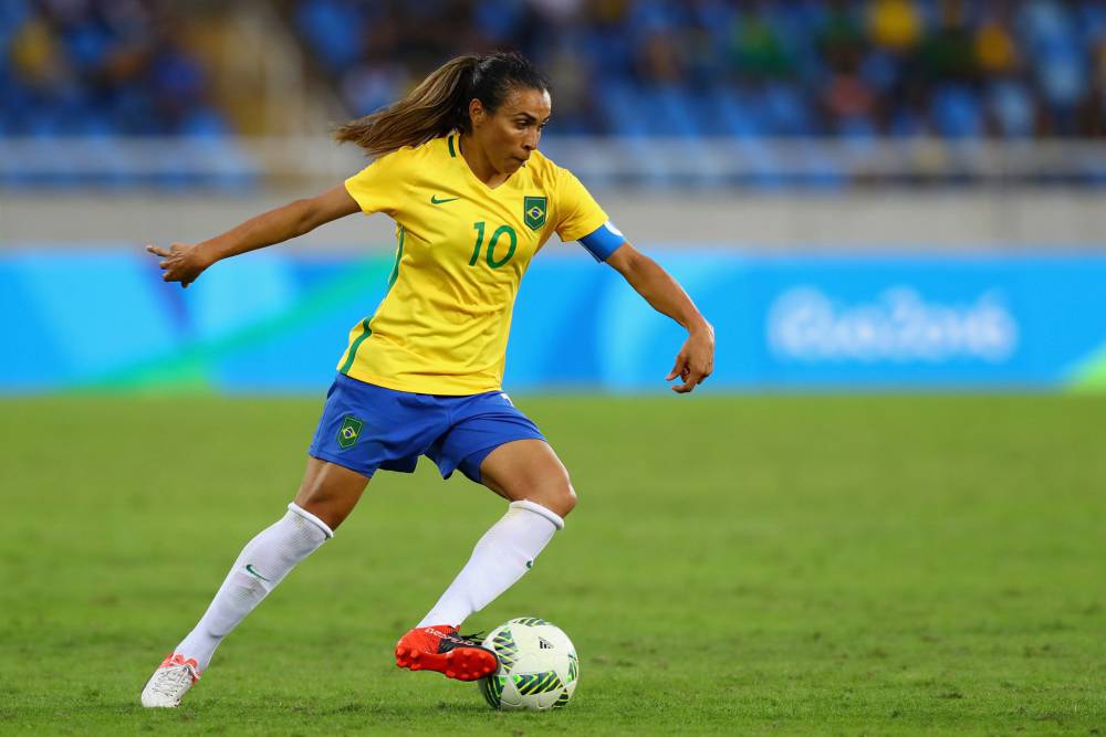 A woman playing soccer in the soccer field