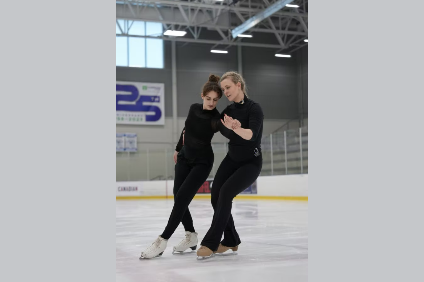 Two women are skating together