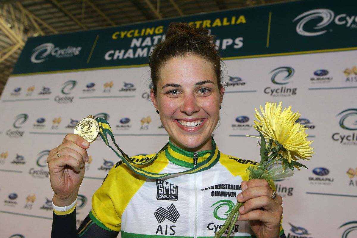 Melissa Hoskin holding a medal and yellow flowers