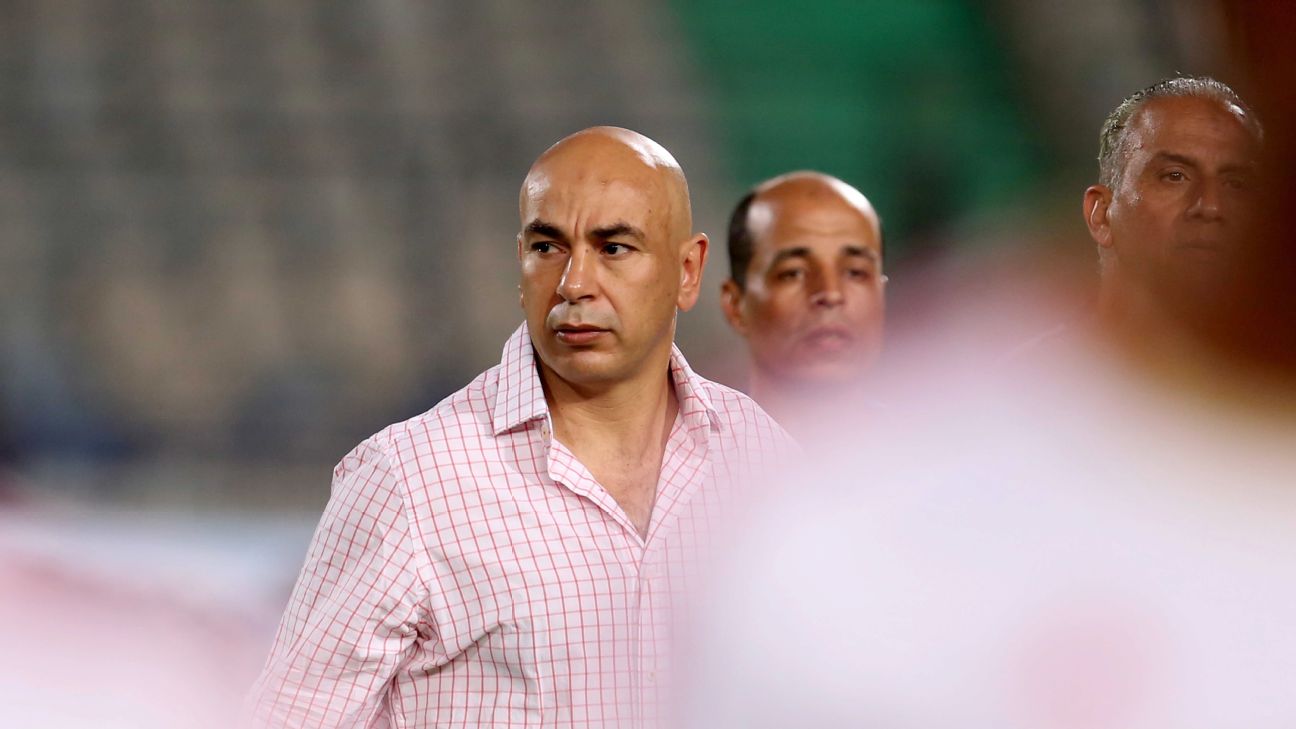 Hossam Hassan wearing a black and red checkered polo